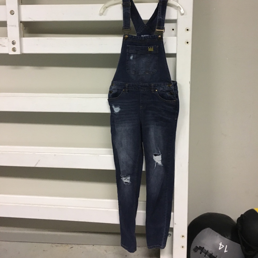 Blue Spice Jean ripped overalls.